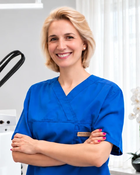 Dr Aleksandra Forkapić in blue scrubs at Aleksandra dental practice.